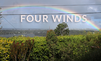 Four Winds home with a rainbow appearing over the horizon
