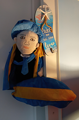 A puppet like image of the author with a surfboard, saying take me to the ocean