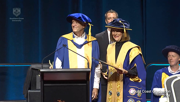 Michael on stage at the Gold Coast Convention Centre recieving the PhD award Michael on stage at the Gold Coast Convention Centre recieving the PhD award